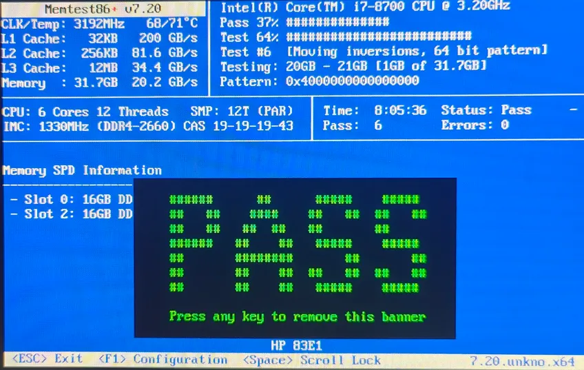 A physical photo of a monitor running Memtest86+, showing a bright green 'PASS' banner and zero errors.